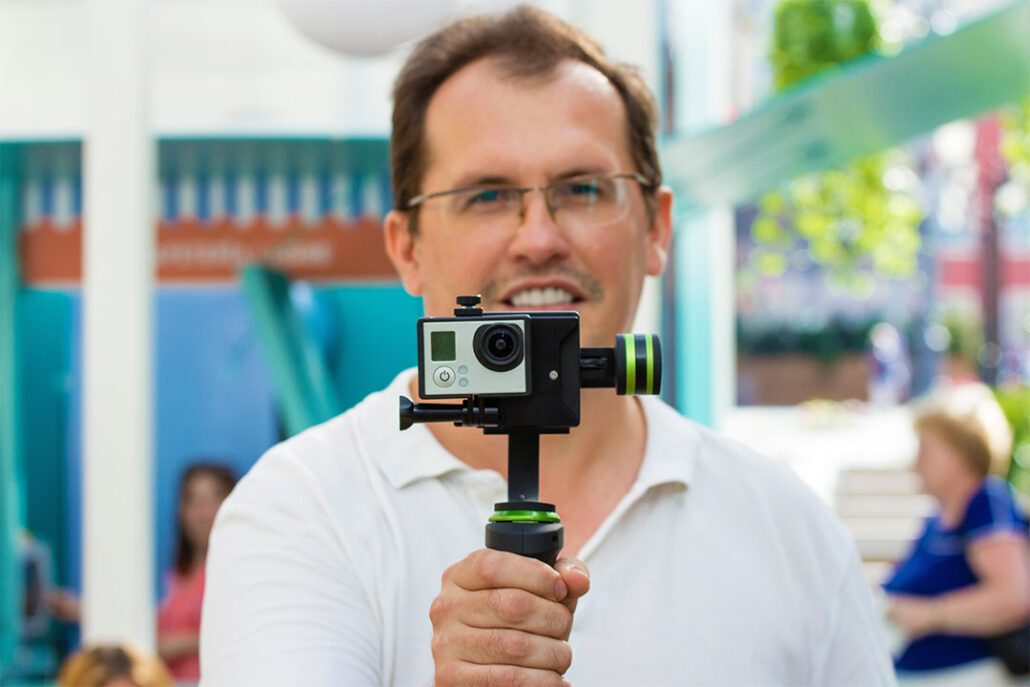 best action camera gimbal held by man looking at camera