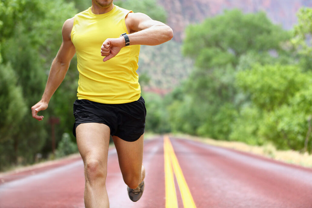 man running with his gps watch 