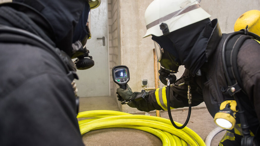 Firefighters using a thermal imaging camera during a structure fire or training exercise